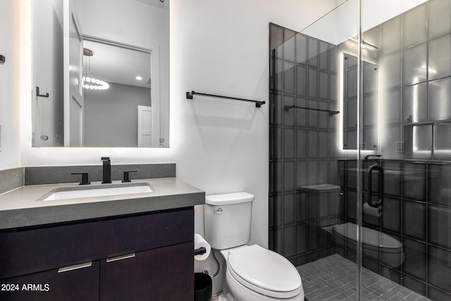 bathroom with vanity, an enclosed shower, and toilet