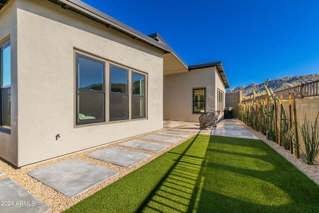 back of house featuring a patio and a lawn