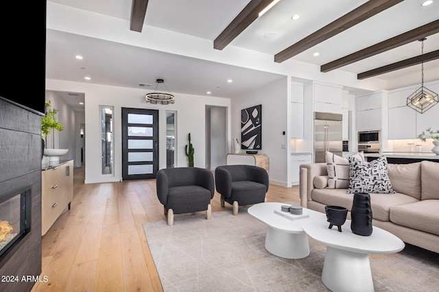 living room with beam ceiling and light hardwood / wood-style floors