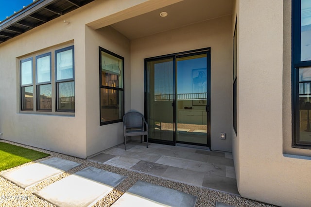 entrance to property featuring a patio area