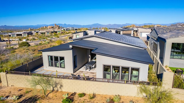 back of house featuring a mountain view and a patio