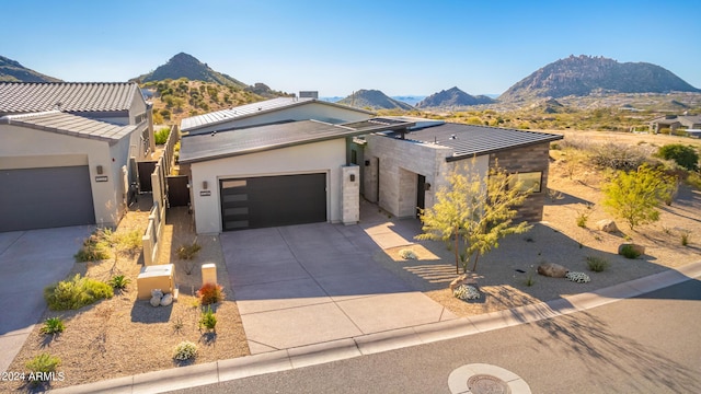 view of front of property with a garage and a mountain view