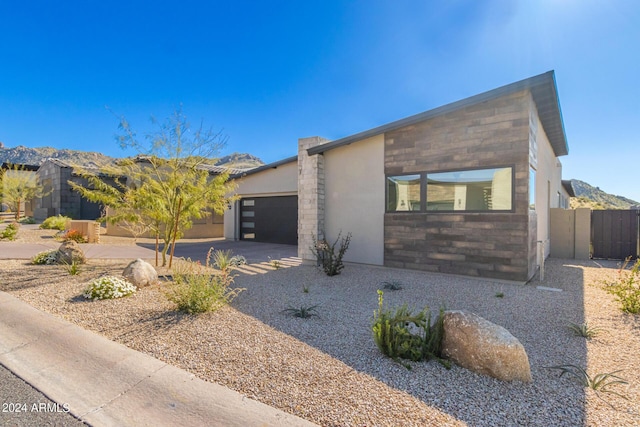 contemporary house featuring a garage and a mountain view