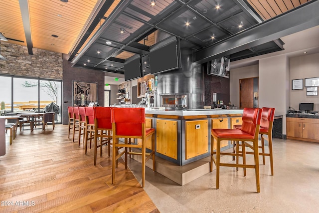 bar with a towering ceiling and wood ceiling