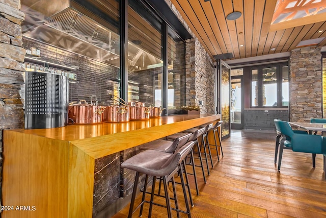 bar with hardwood / wood-style flooring and wood ceiling