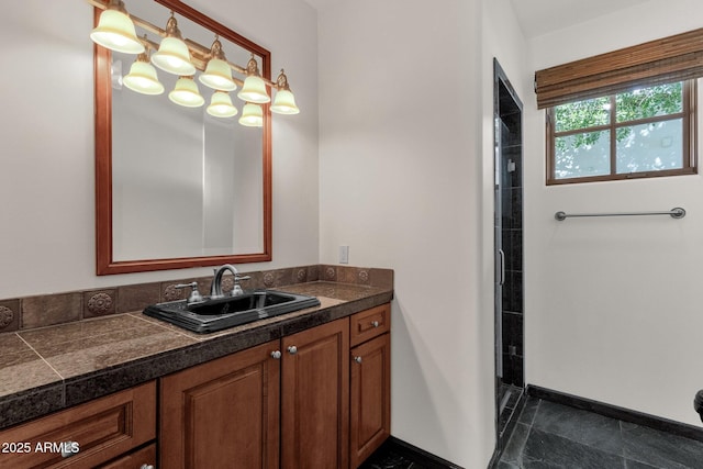 bathroom featuring tiled shower and vanity