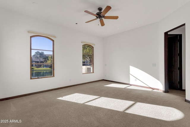 carpeted empty room with ceiling fan