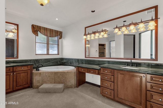 bathroom with vanity and tiled bath