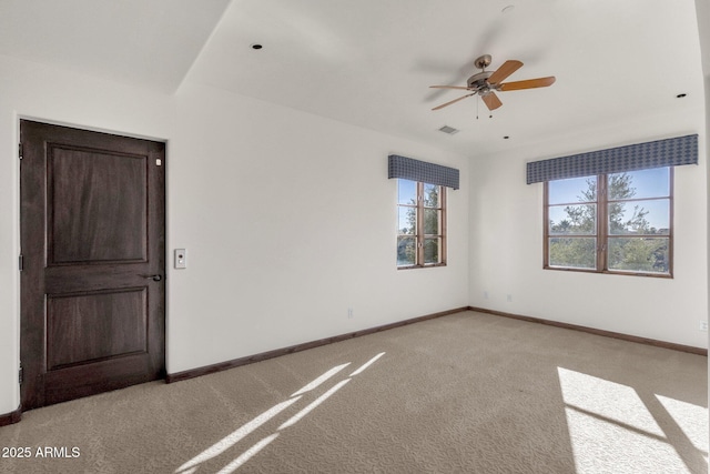 carpeted spare room with ceiling fan