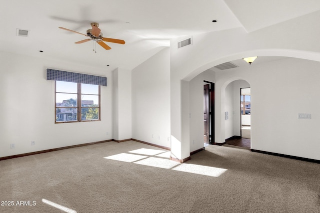 spare room featuring vaulted ceiling, carpet floors, and ceiling fan