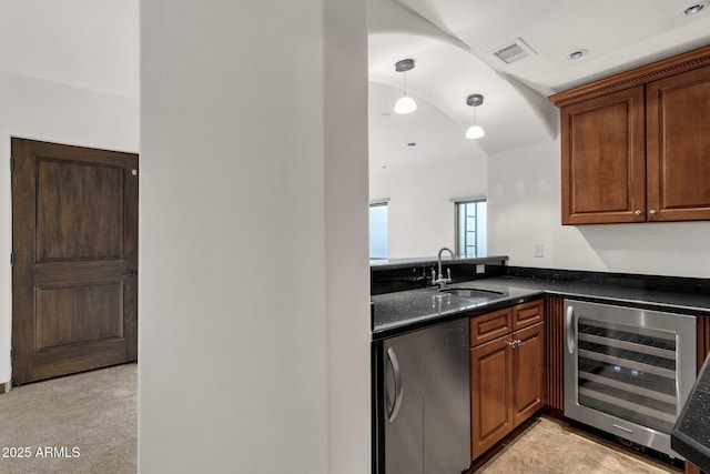 kitchen featuring sink, decorative light fixtures, light carpet, beverage cooler, and stainless steel fridge