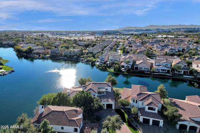 birds eye view of property with a water and mountain view