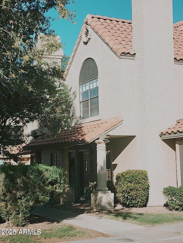 5704 E Aire Libre Ave Unit 1038, Scottsdale, AZ 85254 - view of front of property with a tile roof and stucco siding