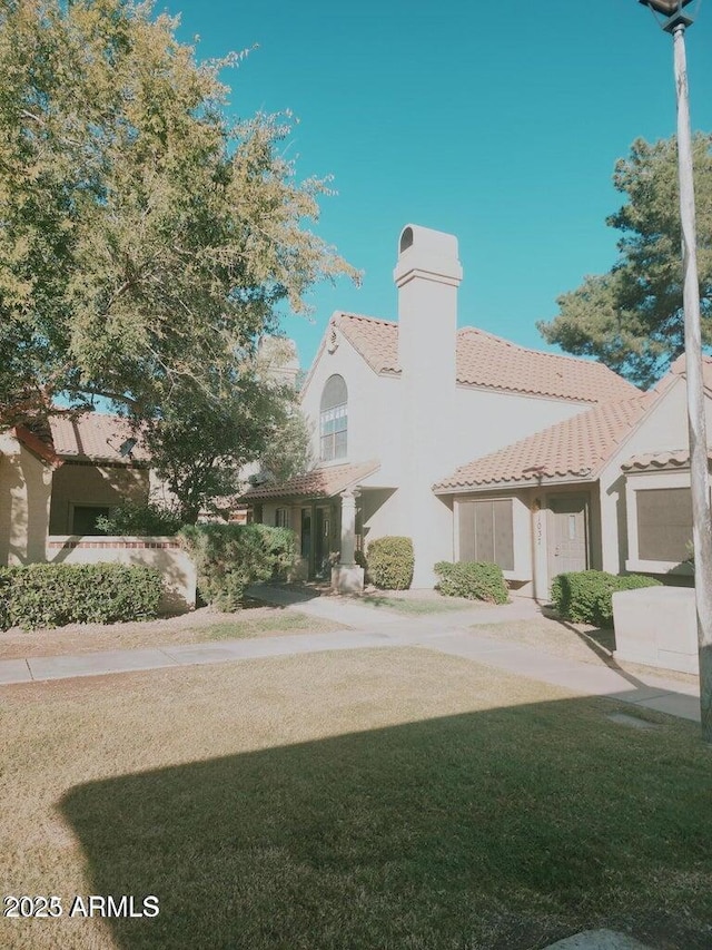 5704 E Aire Libre Ave Unit 1038, Scottsdale, AZ 85254 - mediterranean / spanish-style house featuring a tile roof, stucco siding, and a chimney
