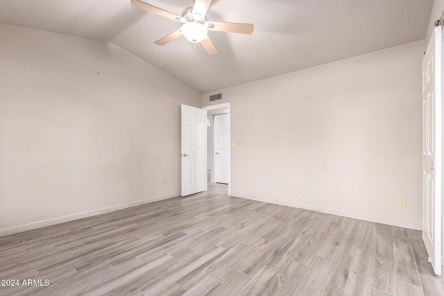 spare room with vaulted ceiling, light hardwood / wood-style flooring, and ceiling fan