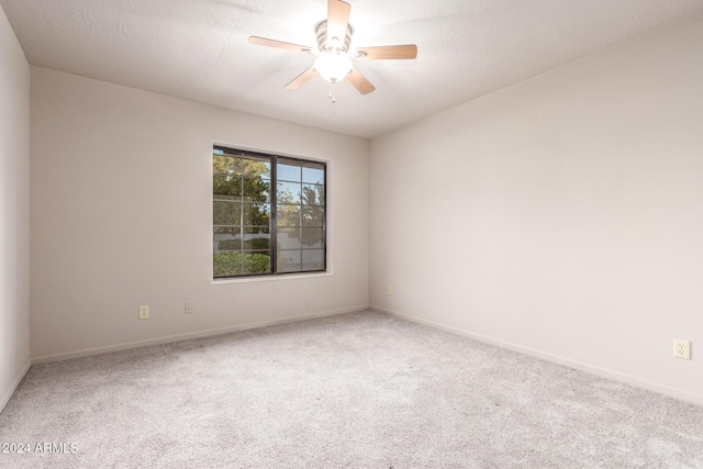 spare room with ceiling fan and carpet floors