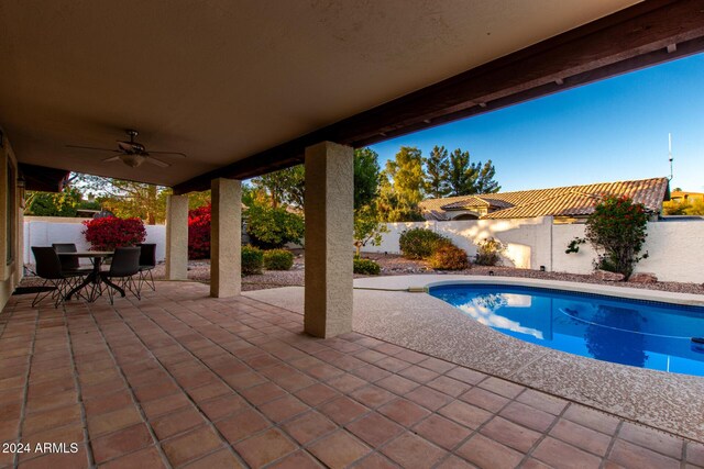 view of pool featuring ceiling fan and a patio