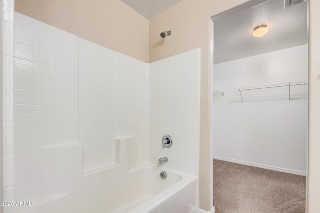 full bathroom with baseboards, shower / bath combination, and a walk in closet