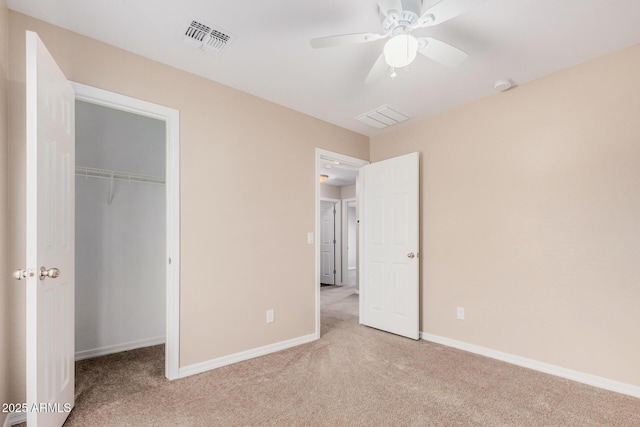 unfurnished bedroom with a closet, carpet, visible vents, and baseboards