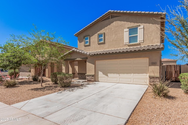 mediterranean / spanish-style home featuring fence, concrete driveway, stucco siding, a tile roof, and a garage