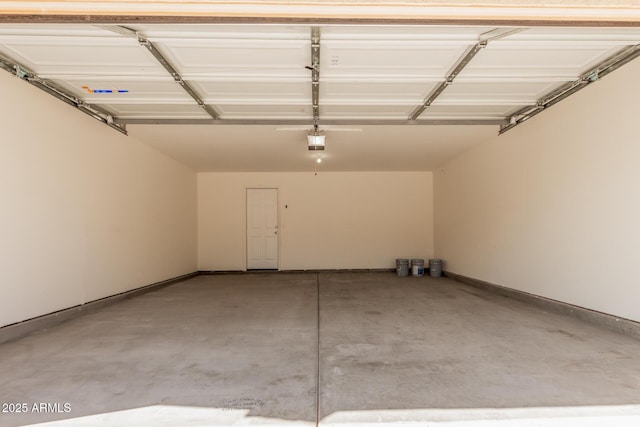 garage with baseboards and a garage door opener