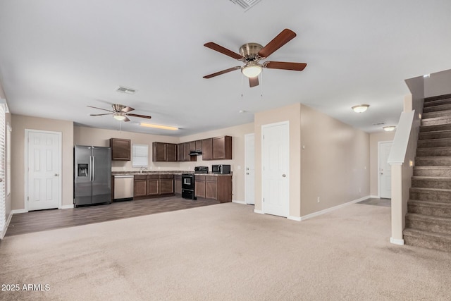 unfurnished living room featuring light carpet, baseboards, visible vents, and ceiling fan