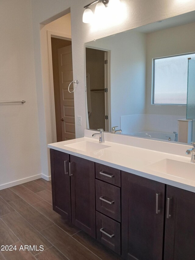 21042 E Camina Buena Vis, Queen Creek, AZ 85142 - full bathroom with double vanity, baseboards, wood finish floors, and a sink