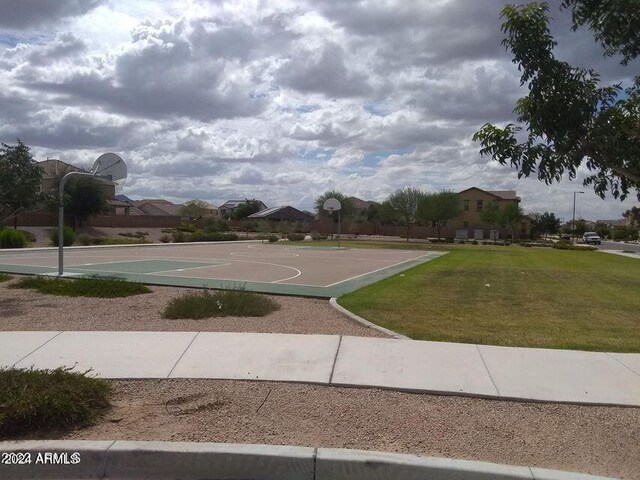 view of sport court featuring a yard