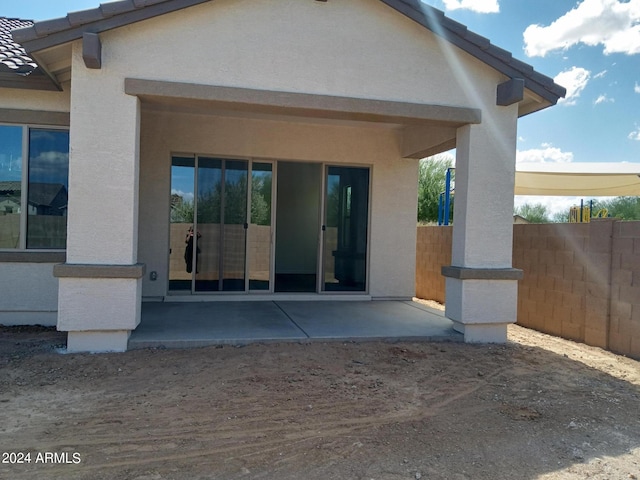 21042 E Camina Buena Vis, Queen Creek, AZ 85142 - view of exterior entry featuring a patio area, fence, a tile roof, and stucco siding