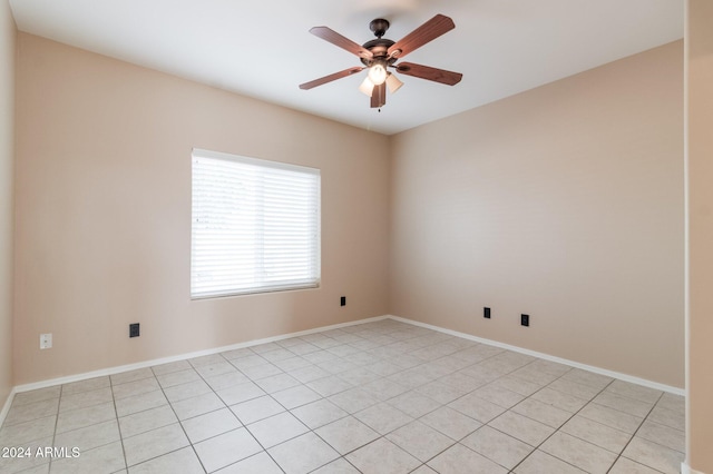 spare room featuring light tile patterned floors and ceiling fan