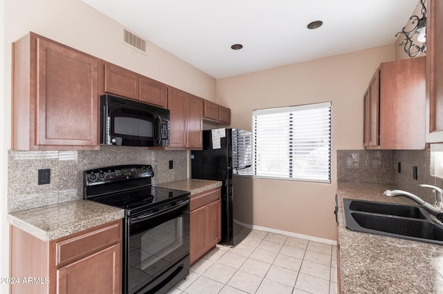 kitchen with sink, black appliances, and backsplash