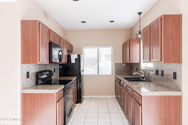 kitchen with hanging light fixtures, backsplash, sink, black appliances, and light tile patterned floors