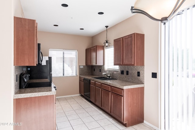 kitchen with sink, decorative backsplash, light tile patterned floors, and black appliances