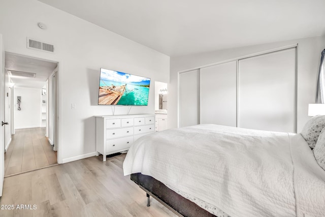 14801 N 25th Dr Unit 2, Phoenix, AZ 85023 - bedroom featuring light wood-style floors, baseboards, and a closet