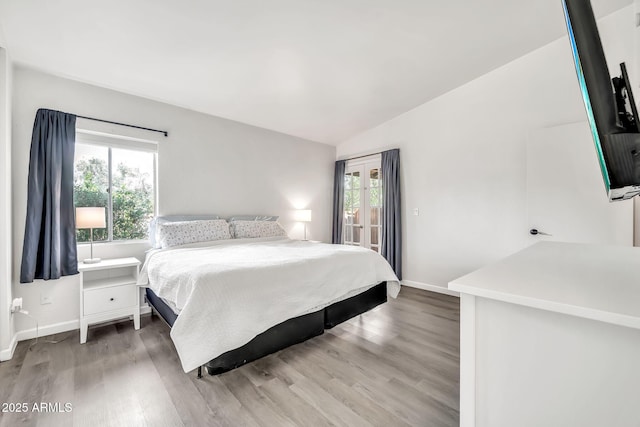 14801 N 25th Dr Unit 2, Phoenix, AZ 85023 - bedroom with lofted ceiling, wood finished floors, baseboards, and access to exterior