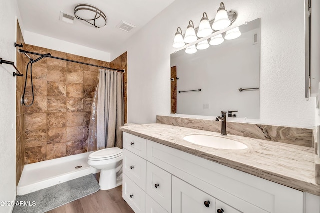 14801 N 25th Dr Unit 2, Phoenix, AZ 85023 - full bathroom featuring toilet, vanity, tiled shower, and wood finished floors