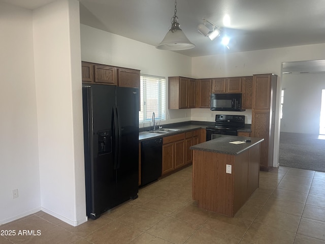 kitchen featuring a center island, decorative light fixtures, black appliances, light tile patterned flooring, and sink