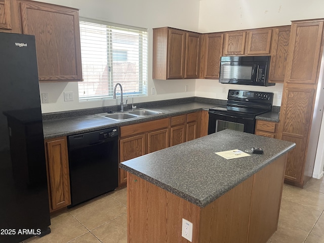 kitchen with sink, light tile patterned floors, a center island, and black appliances