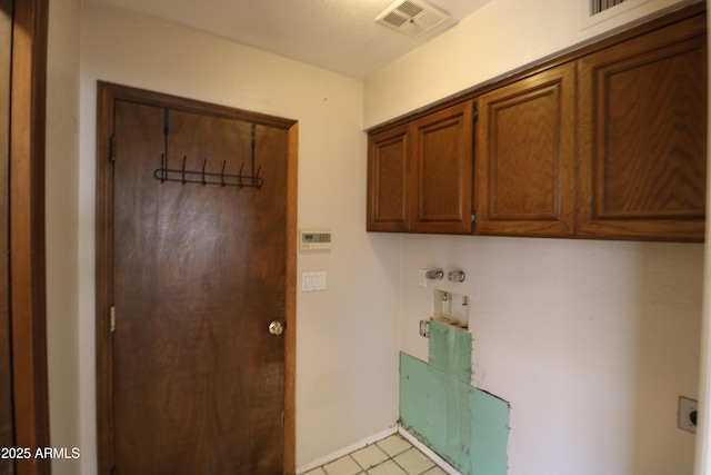 laundry room featuring visible vents, cabinet space, and electric dryer hookup