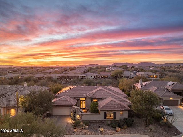 aerial view at dusk featuring a mountain view