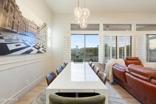 dining area with a chandelier and light wood-type flooring