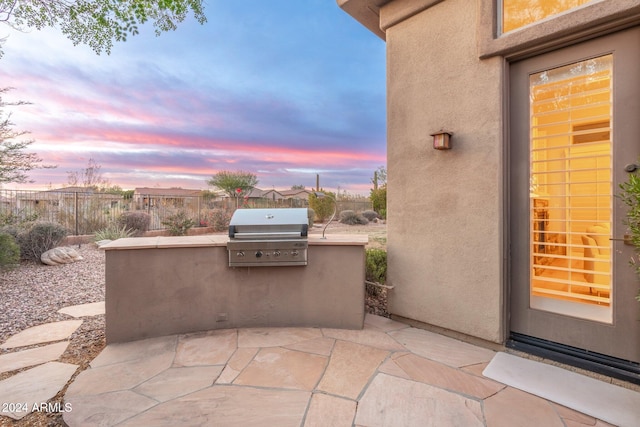 patio terrace at dusk with grilling area and area for grilling