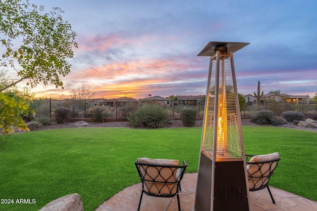 yard at dusk with a patio area