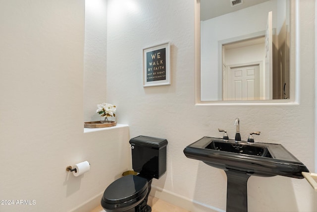 bathroom with toilet and sink