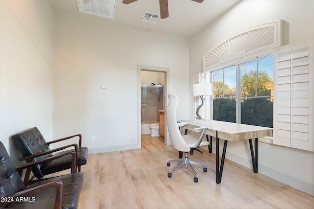 home office featuring ceiling fan and light hardwood / wood-style flooring