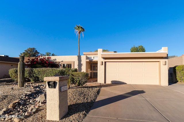 pueblo-style home with a garage