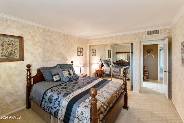 bedroom featuring a closet, light colored carpet, and ornamental molding