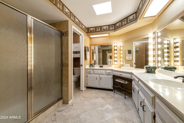 bathroom featuring vanity, toilet, and a shower with shower door