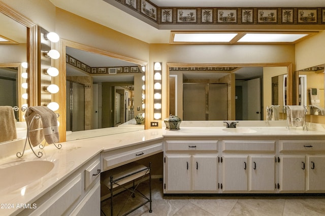 bathroom featuring tile patterned floors, vanity, and a shower with shower door