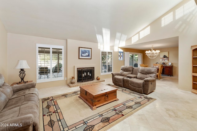 living room with a fireplace, light tile patterned floors, and a notable chandelier